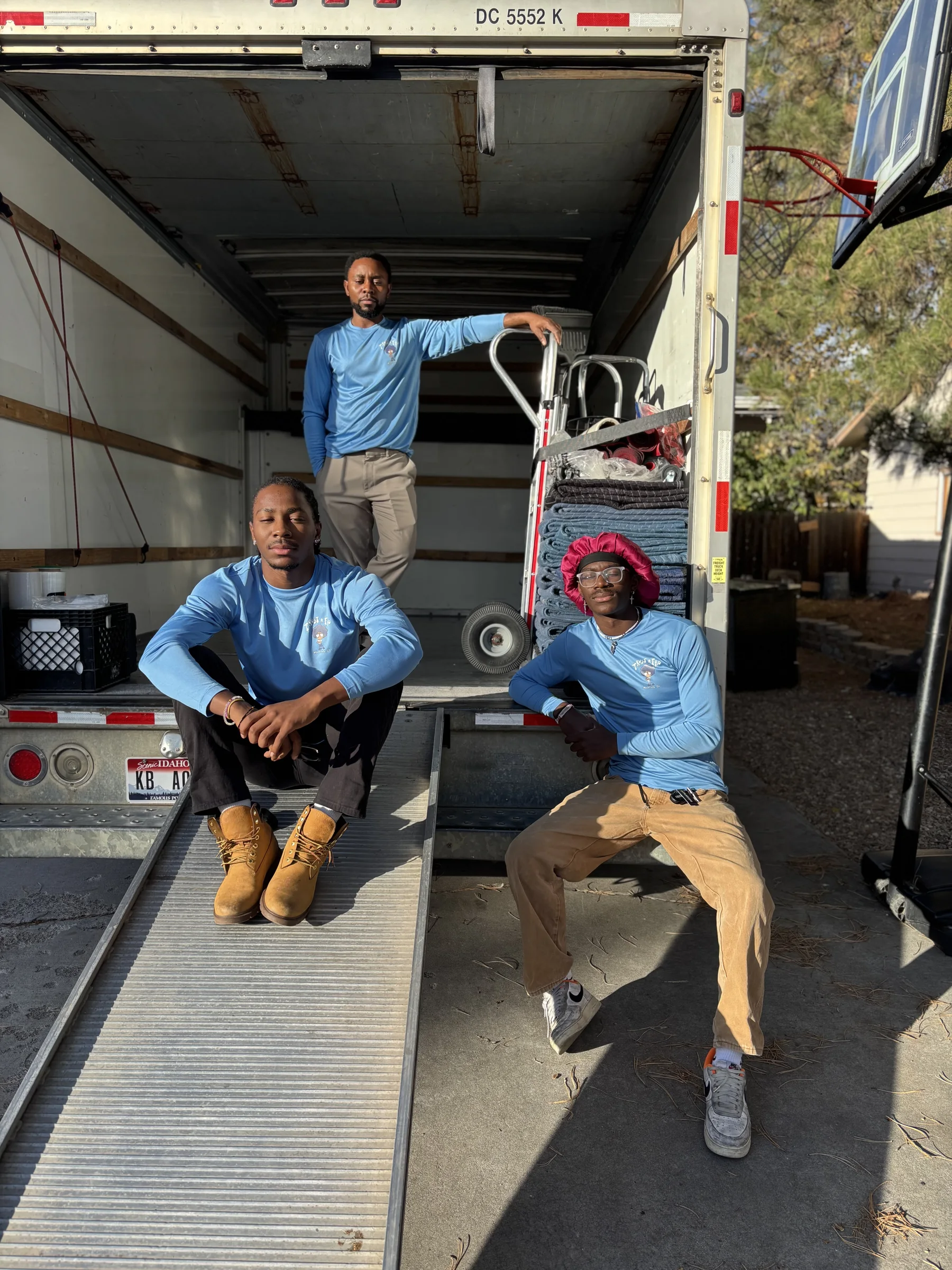 Three Trust A Fro movers posing on the truck ramp